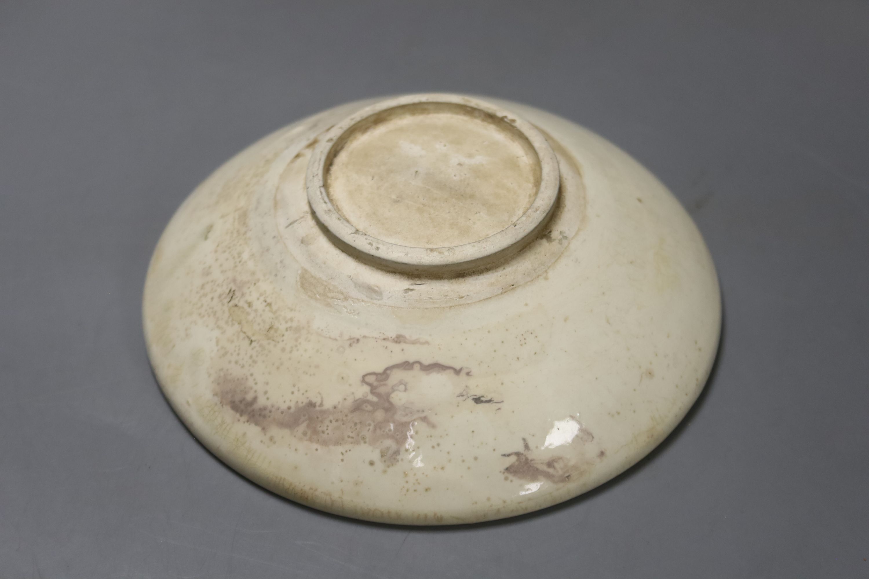 A Chinese Han terracotta model of a standing pig, 17cm long 12cm high, together with two further modelled terracotta figures and a small white glazed Chinese porcelain footed dish, diameter 14cm 4cm high